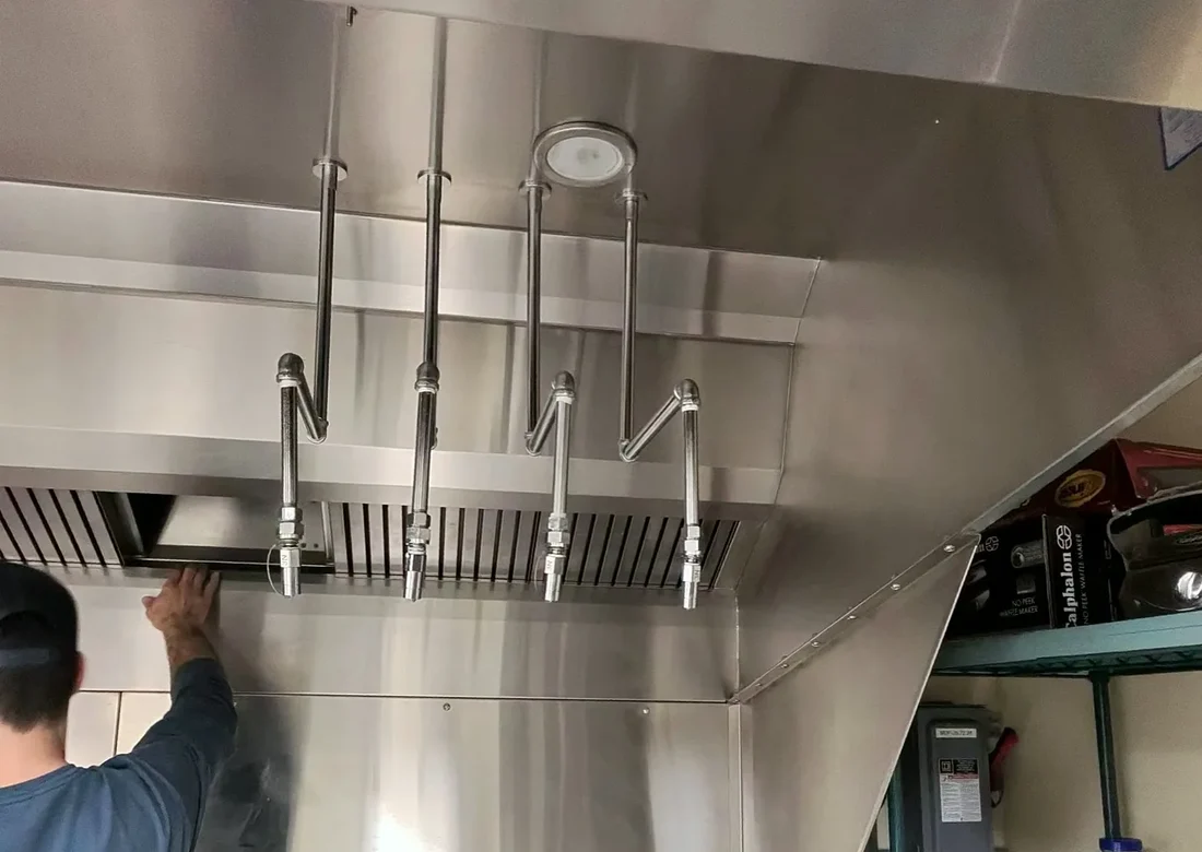 Kajun Hood Cleaning team reviewing a kitchen exhaust cleaning standard